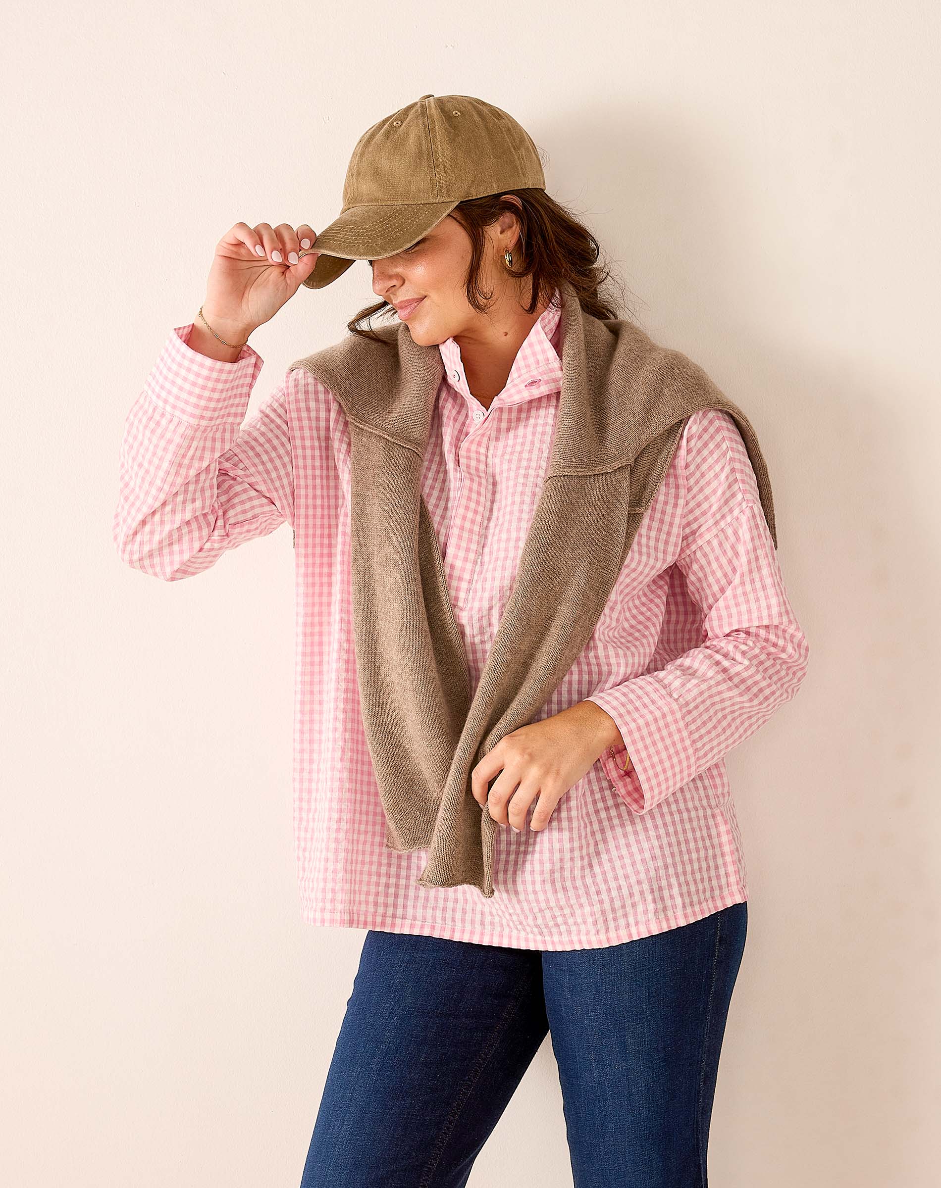 Ladies' travel-ready light pink gingham button-down shirt featuring a relaxed fit and soft cotton blend fabric.