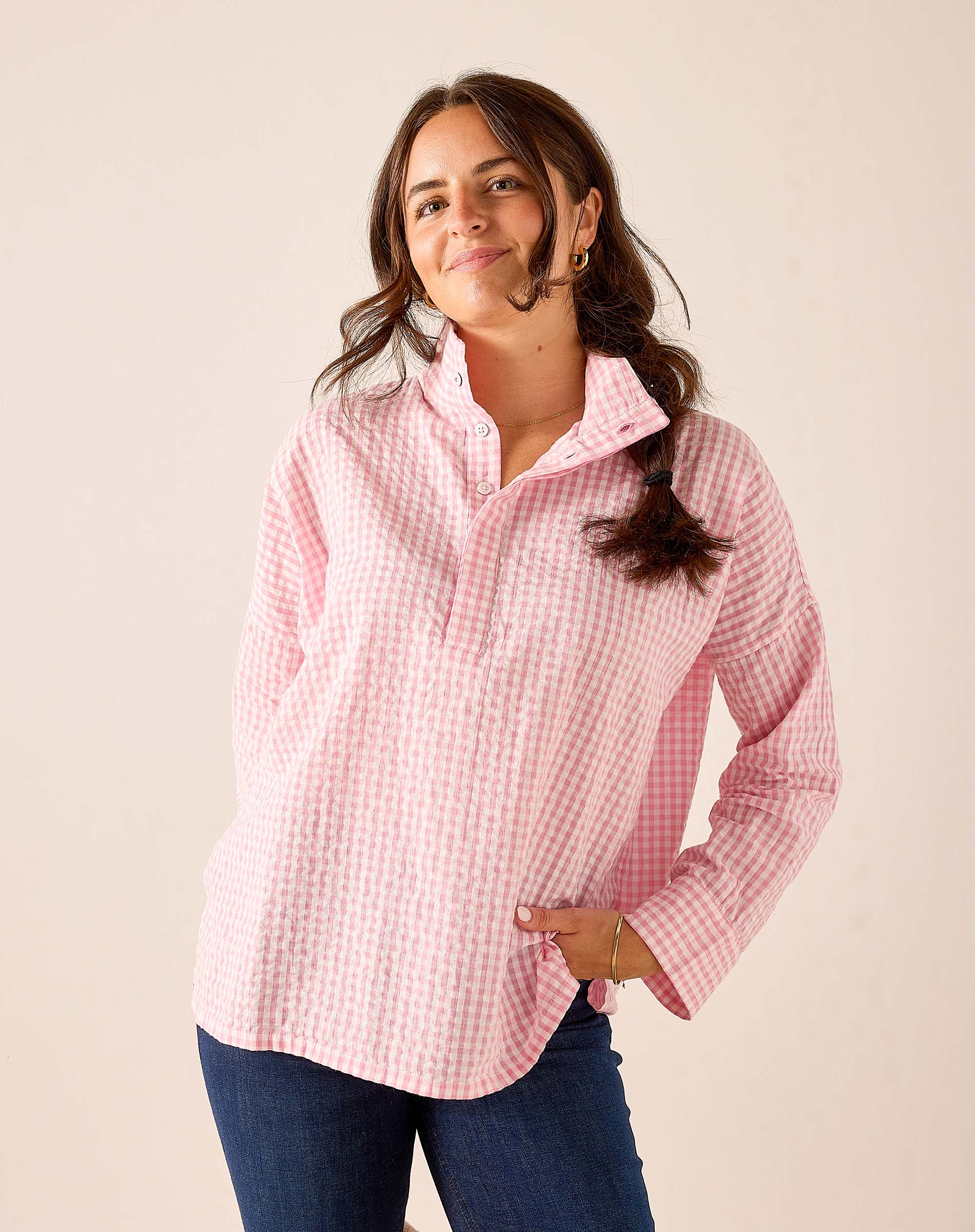 Light pink gingham button-down shirt with a collar and long sleeves.