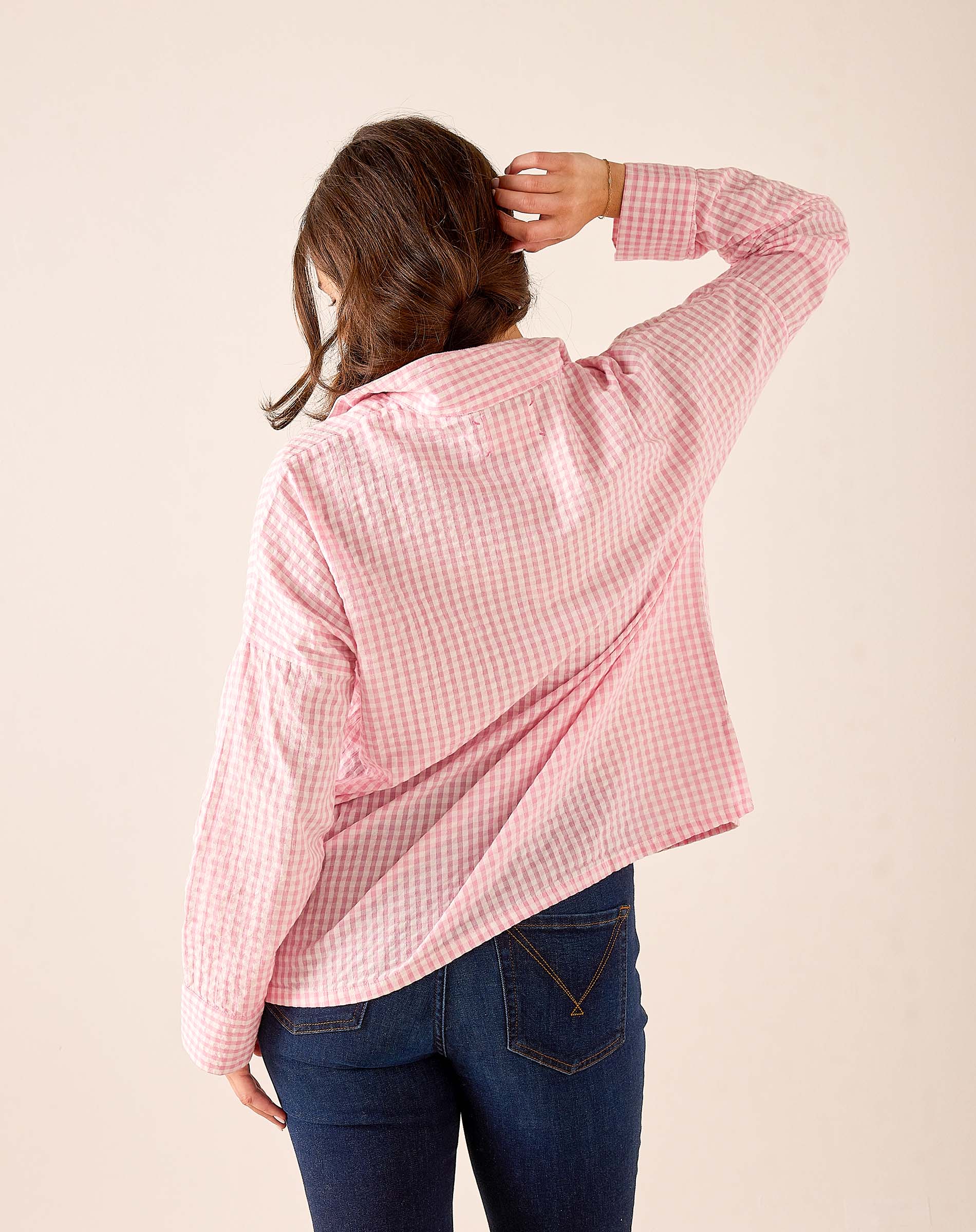 Light pink gingham button-down shirt with a relaxed fit and long sleeves.