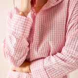 Light pink gingham button-up blouse with puff sleeves and a ruffled collar.