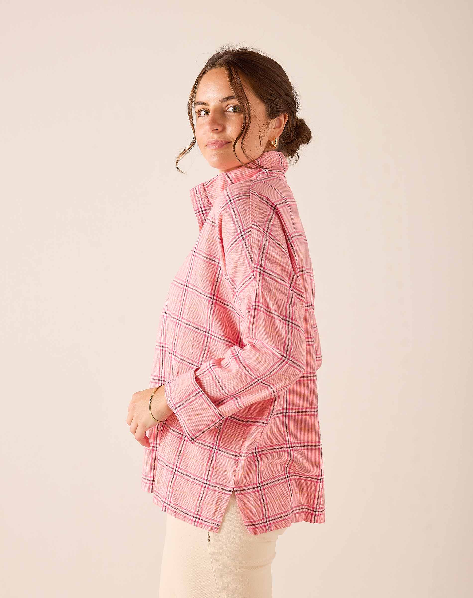 Pink plaid button-down shirt with long sleeves and a relaxed fit.