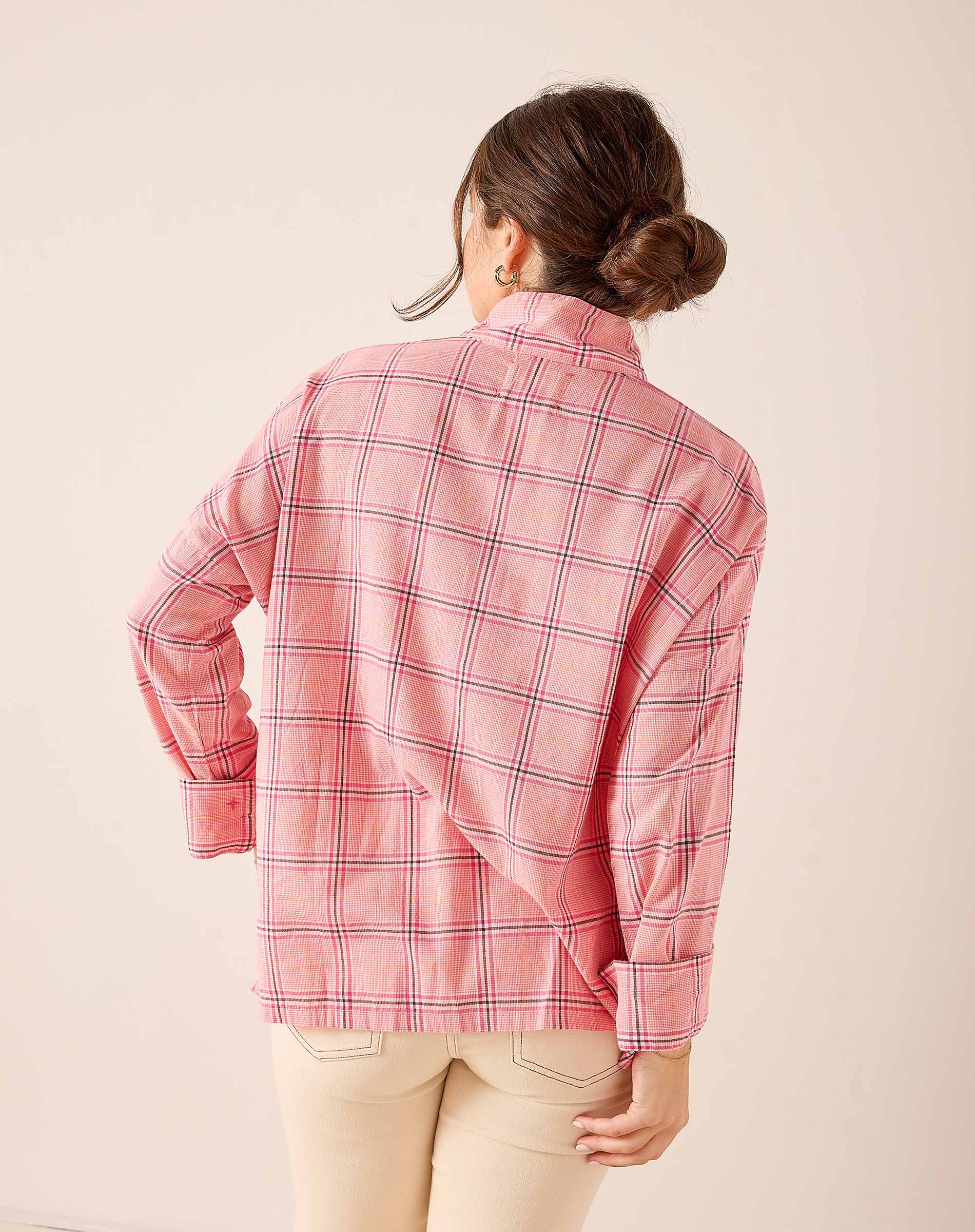 Back view of the pink and navy plaid button-down shirt featuring a relaxed fit and soft cotton fabric.