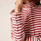 Red and white striped shirt worn by a person on a plain background