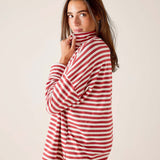 Woman wearing a red and white striped shirt against a plain background