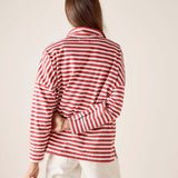 Person wearing a red and white striped shirt against a plain background