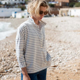 Woman wearing a striped shirt and sunglasses on a beach