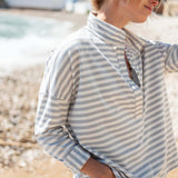 Person wearing a striped shirt on a beach