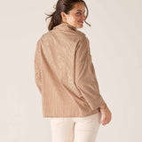 Woman wearing a brown striped shirt against a white background