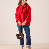 Women's travel-friendly cardinal red oversized tunic top with a half-zip neckline and three-quarter sleeves.