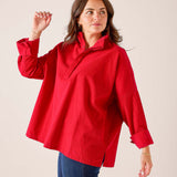 Cardinal red oversized linen blend top with a buttoned collar and wide sleeves.