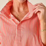 Person wearing a red and white striped shirt with a close-up of the collar.