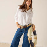Woman holding a decorative item against a plain background
