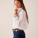 White oversized poplin cotton tuxedo top with wide sleeves and a buttoned cuff.