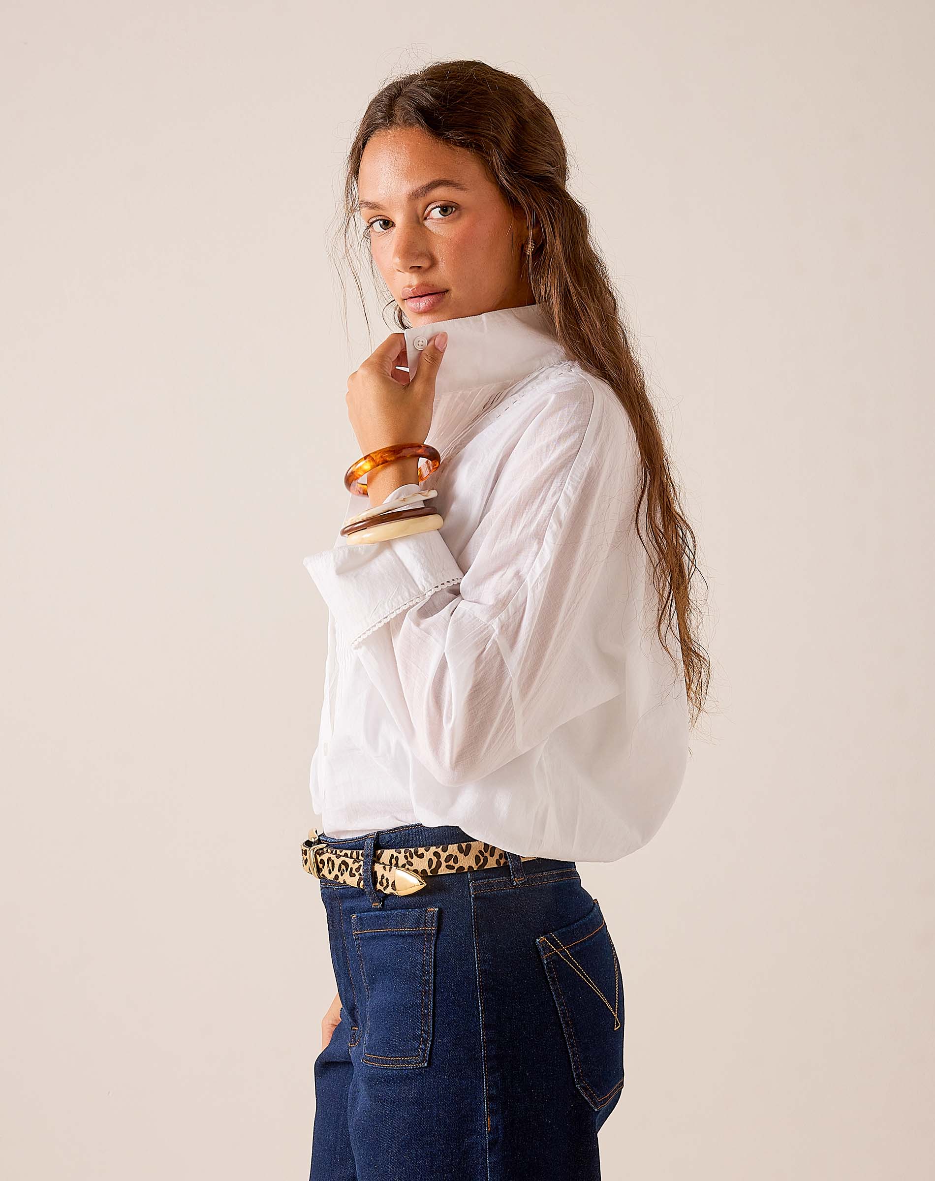 White oversized poplin cotton tuxedo top with wide sleeves and a buttoned cuff.