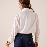 Back view of women's travel-friendly white oversized button-up cotton shirt with large cuffs.