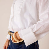 White tunic-style cotton top featuring pintuck detailing and a pleated front.
