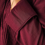 Burgundy tuxedo blouse with gathered detail and embroidered trim.