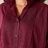Burgundy button-down shirt with pleated tuck detailing.