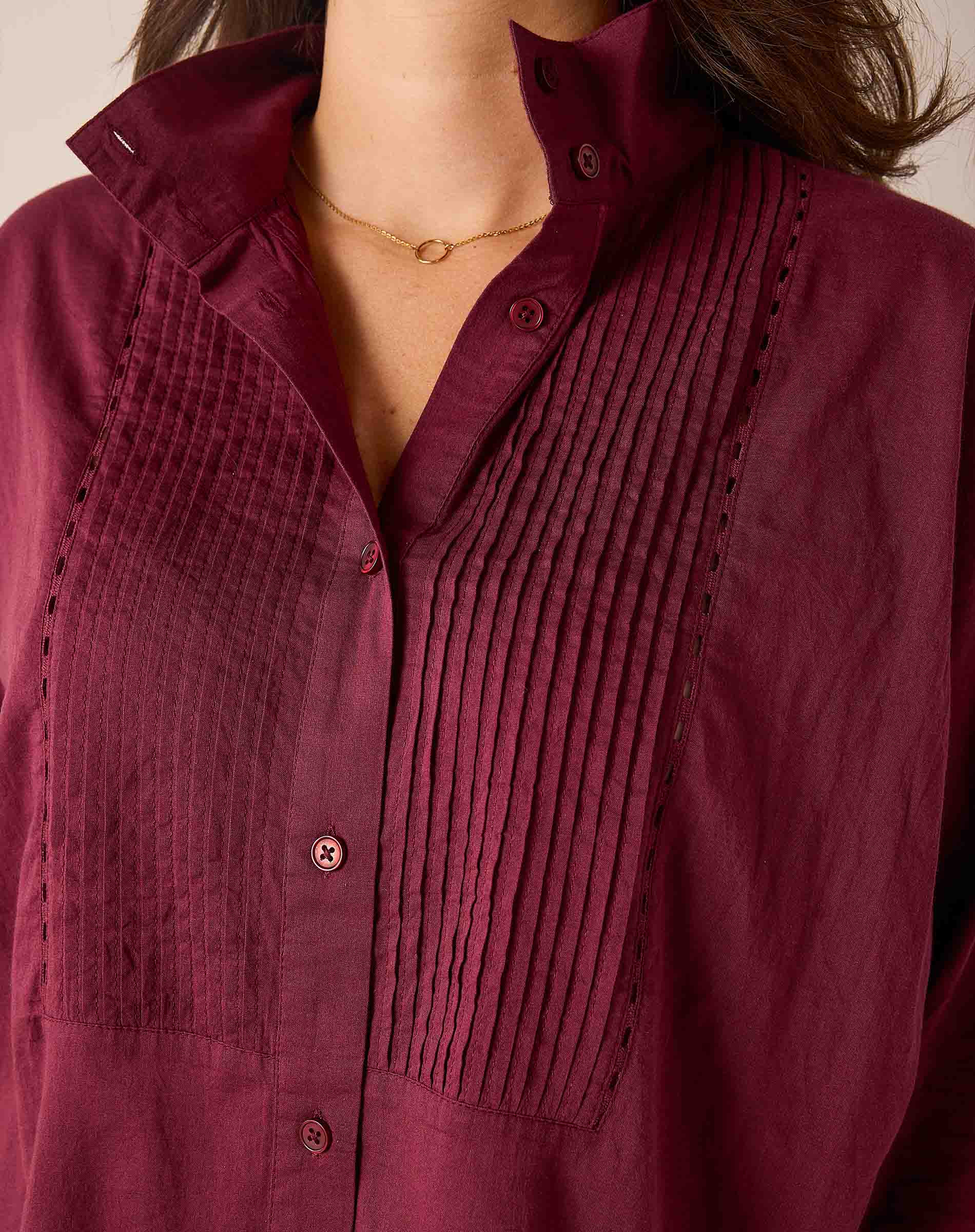 Burgundy button-down shirt with pleated tuck detailing.