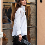 White structured tuxedo top in a crisp linen-blend fabric with an oversized collar and buttons.