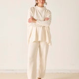 Cream chenille knit pants featuring a relaxed fit and comfortable texture.