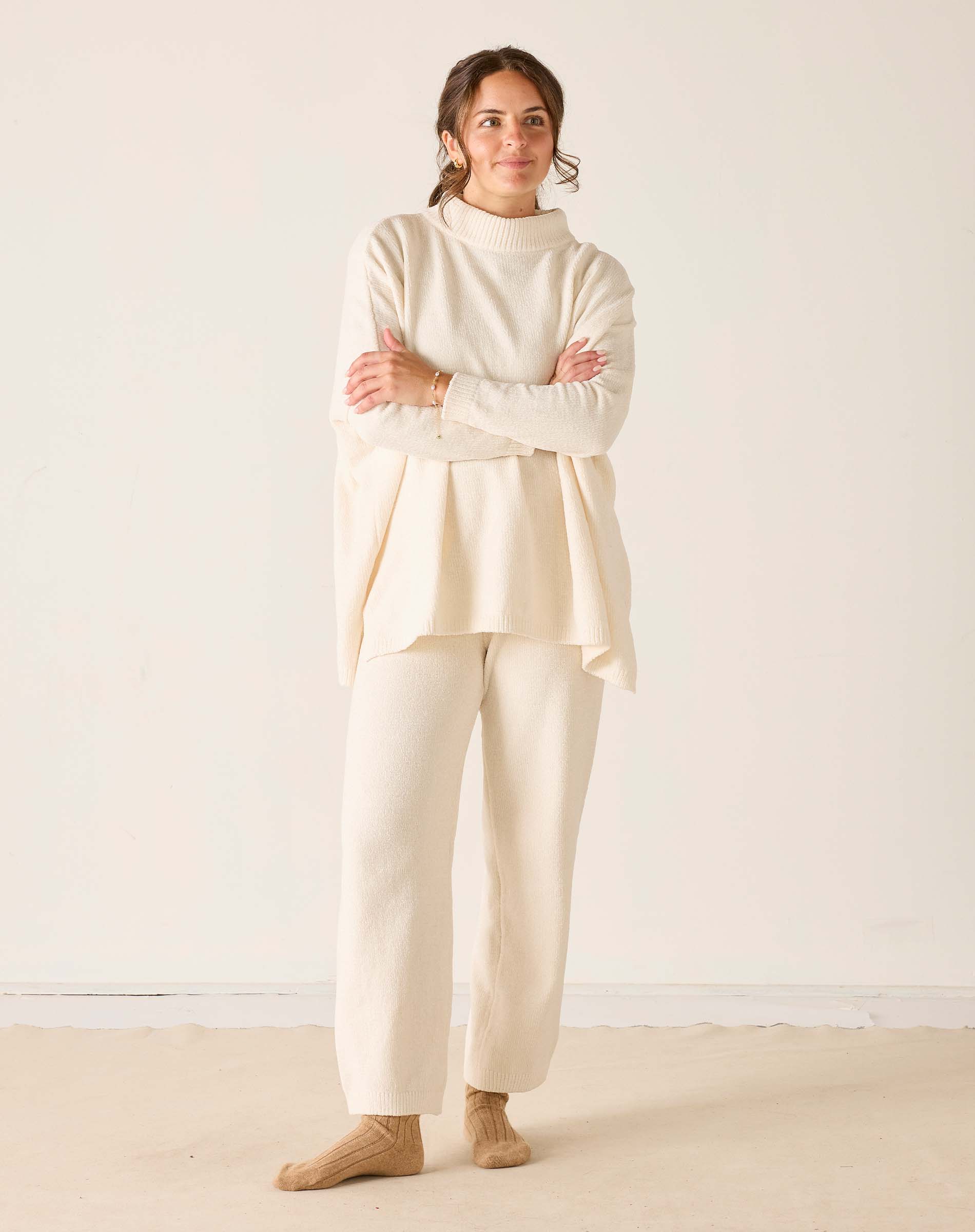 Cream chenille knit pants featuring a relaxed fit and comfortable texture.