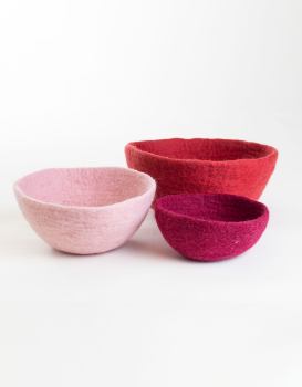 small, medium, and large red and pink felt bowls on a white background