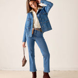 MERSEA ladies' travel-ready mid-wash denim field jacket over a cream top and matching jeans.