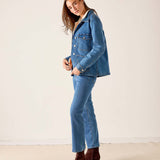Medium blue denim field jacket with front pockets and long sleeves.