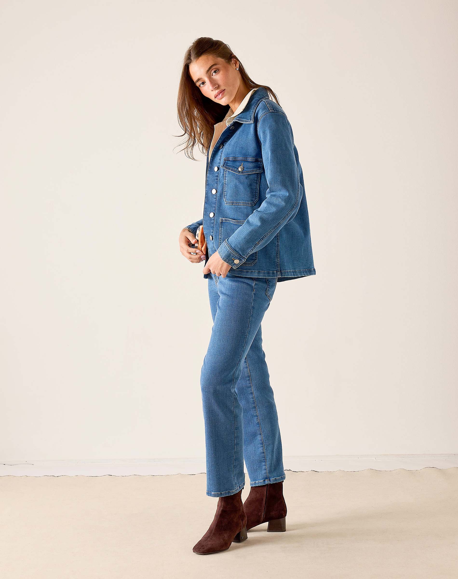 Medium blue denim field jacket with front pockets and long sleeves.