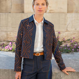 Women's travel-friendly rinse blue patterned button-front jacket with golden thread embroidery and a structured fit.