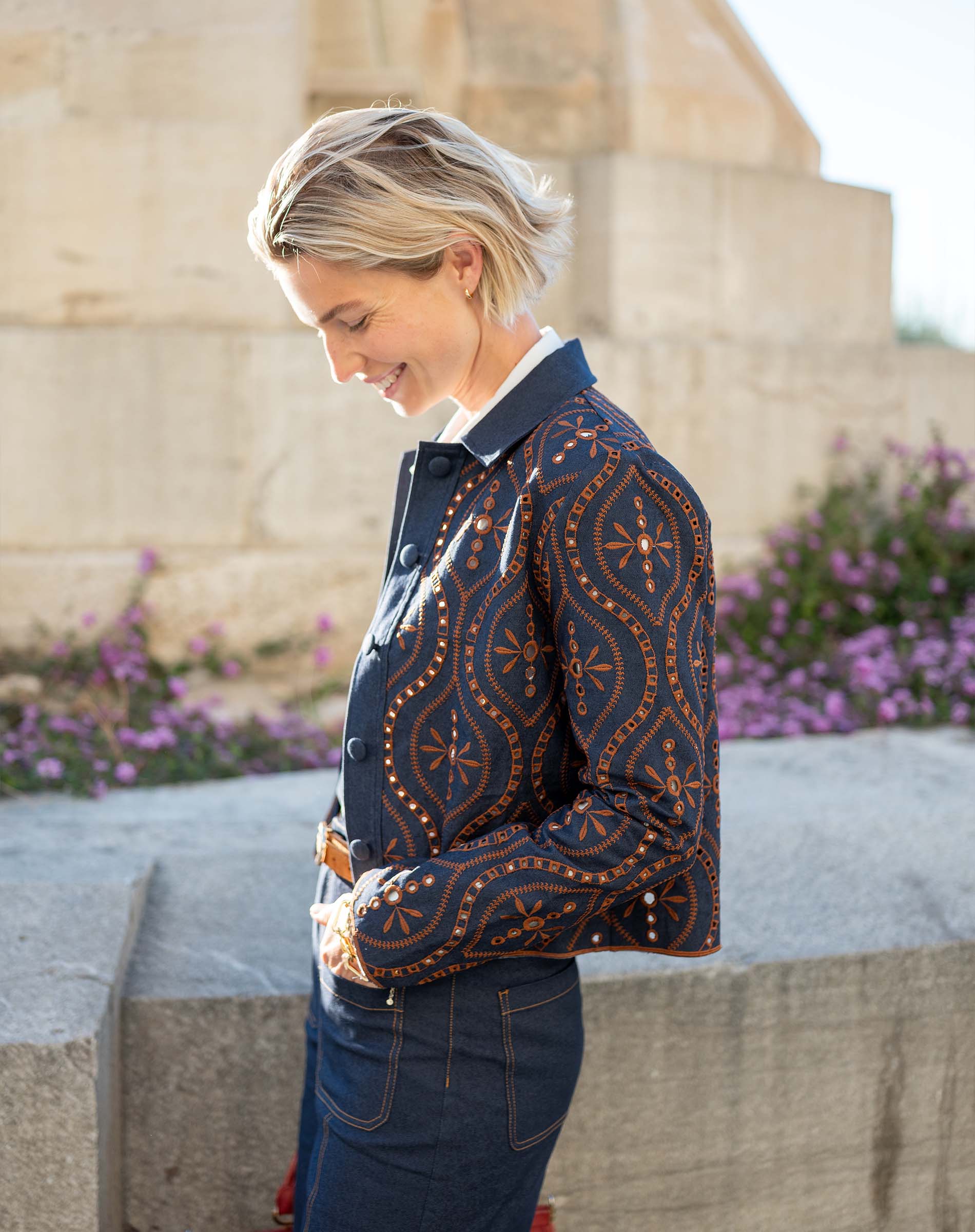 Navy blue patterned knit jacket with button details.