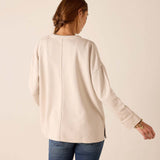 Back view of the bone knit top with dropped shoulders and long sleeves.