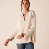 Bone-colored tunic top with a split neckline and wide ribbed cuffs.