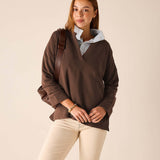 Espresso knit top with a wide neckline and a light blue button-down shirt layered underneath.