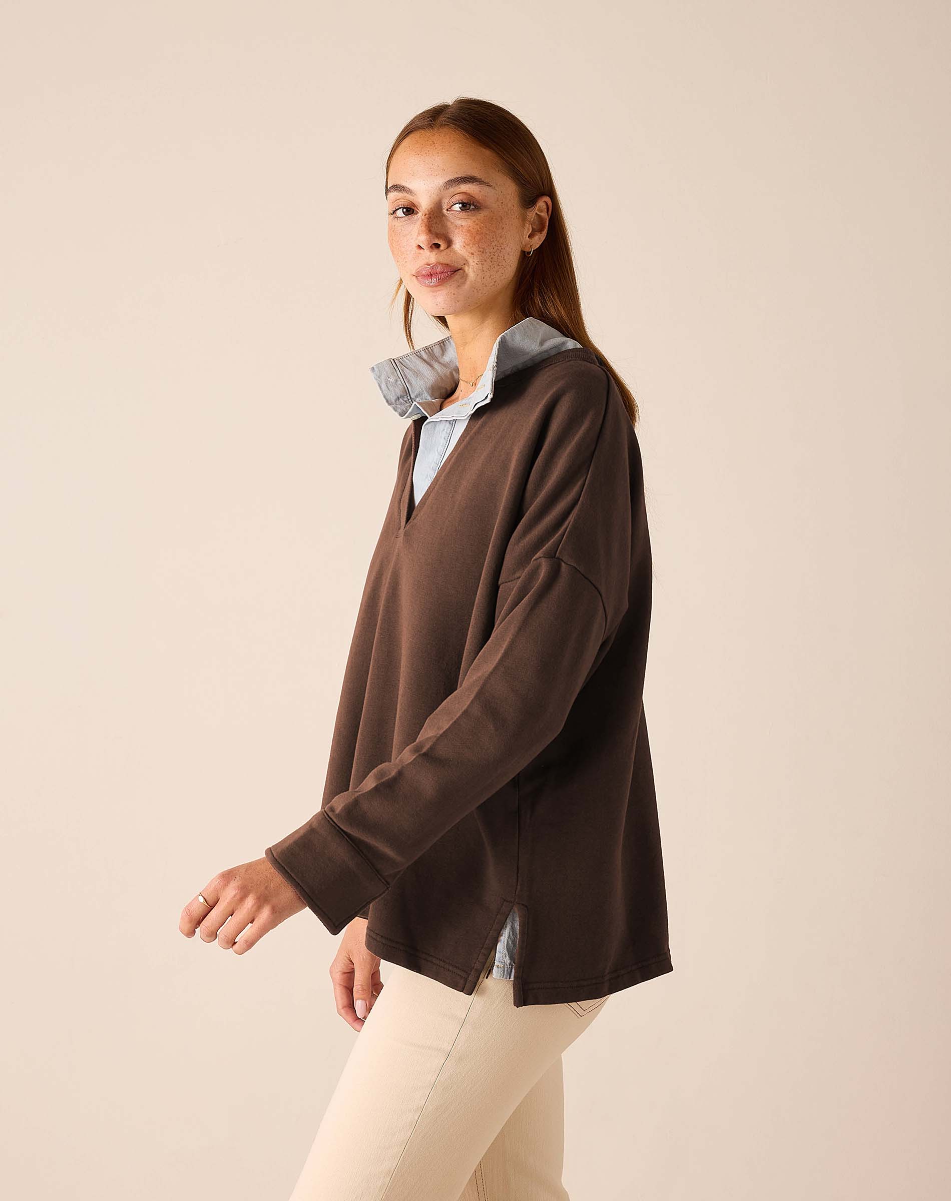 Espresso brown knit top with a wide neckline and long sleeves.