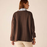 Back view of the espresso knit top with dropped shoulders and wide cuffs.