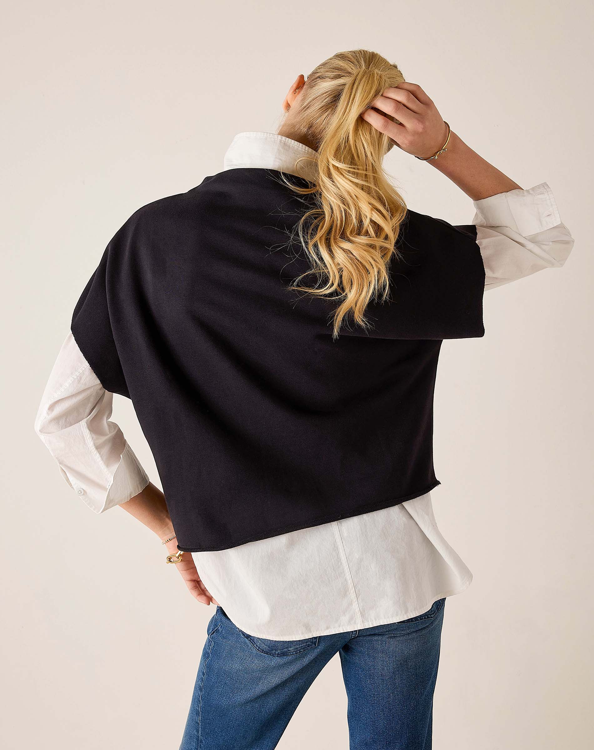 Back view of women's travel-friendly black dolman top with an oversized fit.
