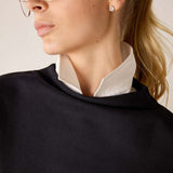 Black dolman top with a white collar layered over it.