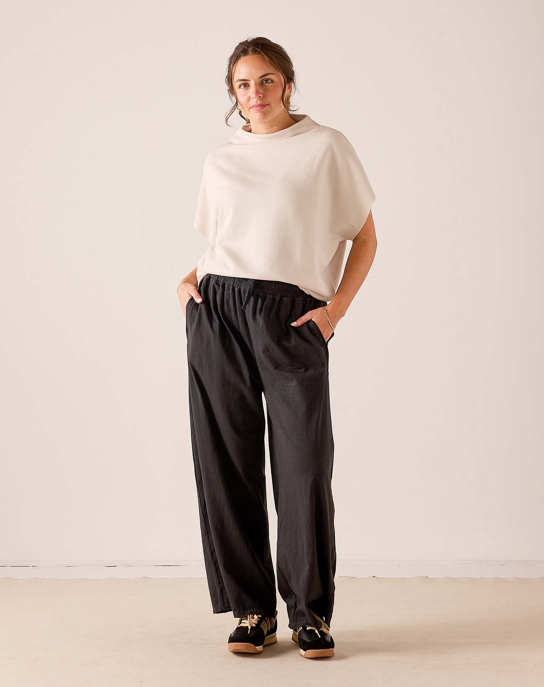 MERSEA ladies' travel-ready bone colored dolman sleeve knit top with a relaxed fit and wide sleeves.