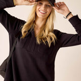 Women's travel-friendly black long-sleeve tunic with front pockets and a buttoned placket.