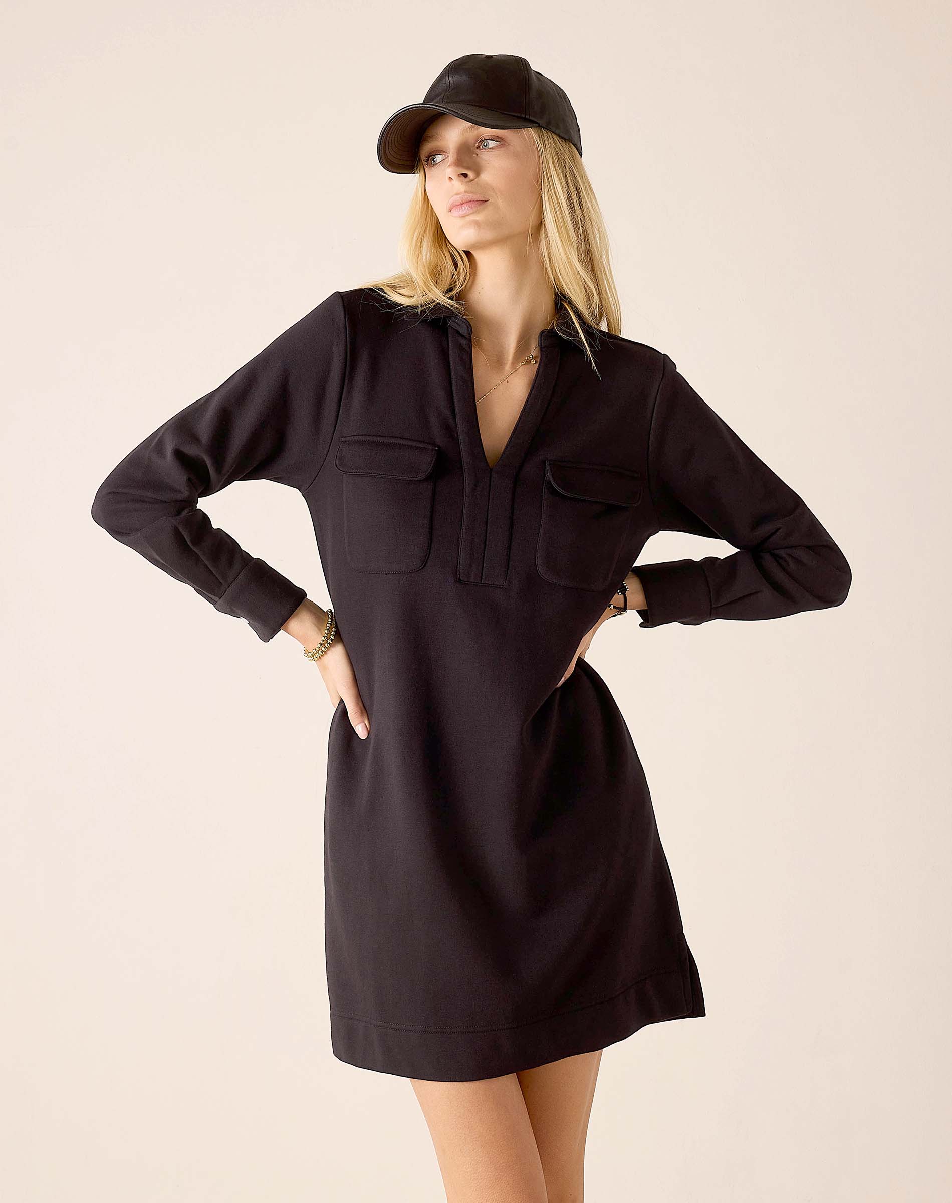 Black knit cotton blend Frenchie dress with a V-neckline and front flap pockets.