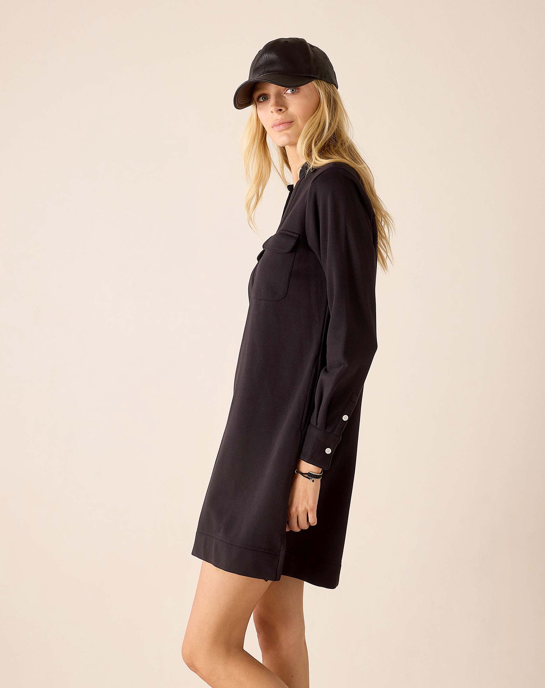 Black relaxed fit cotton dress with a front pocket and buttoned cuff details.