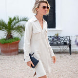 Bone white shirt dress with button details and front pockets.
