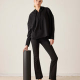 MERSEA ladies' travel-ready black hooded tunic top with drawstring details and matching flared trousers.