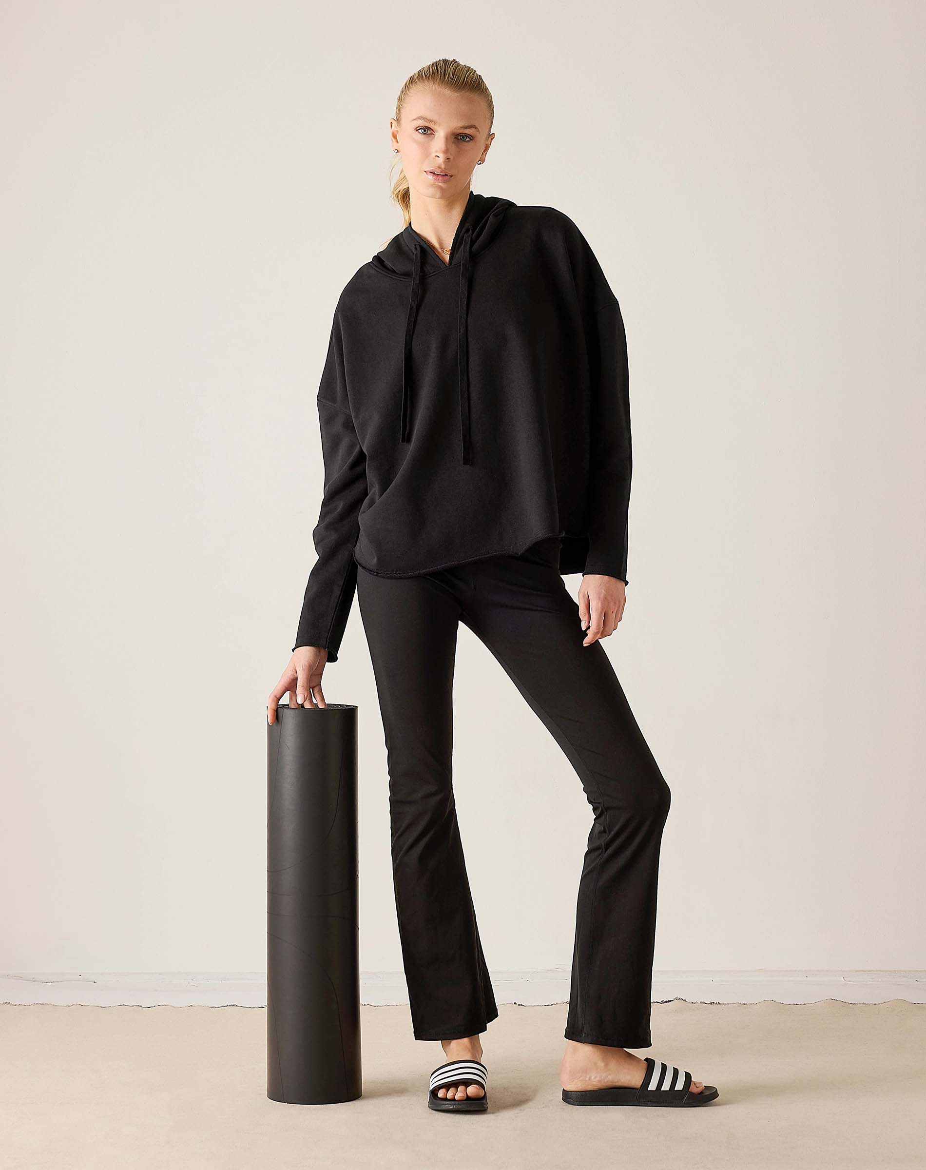 MERSEA ladies' travel-ready black hooded tunic top with drawstring details and matching flared trousers.