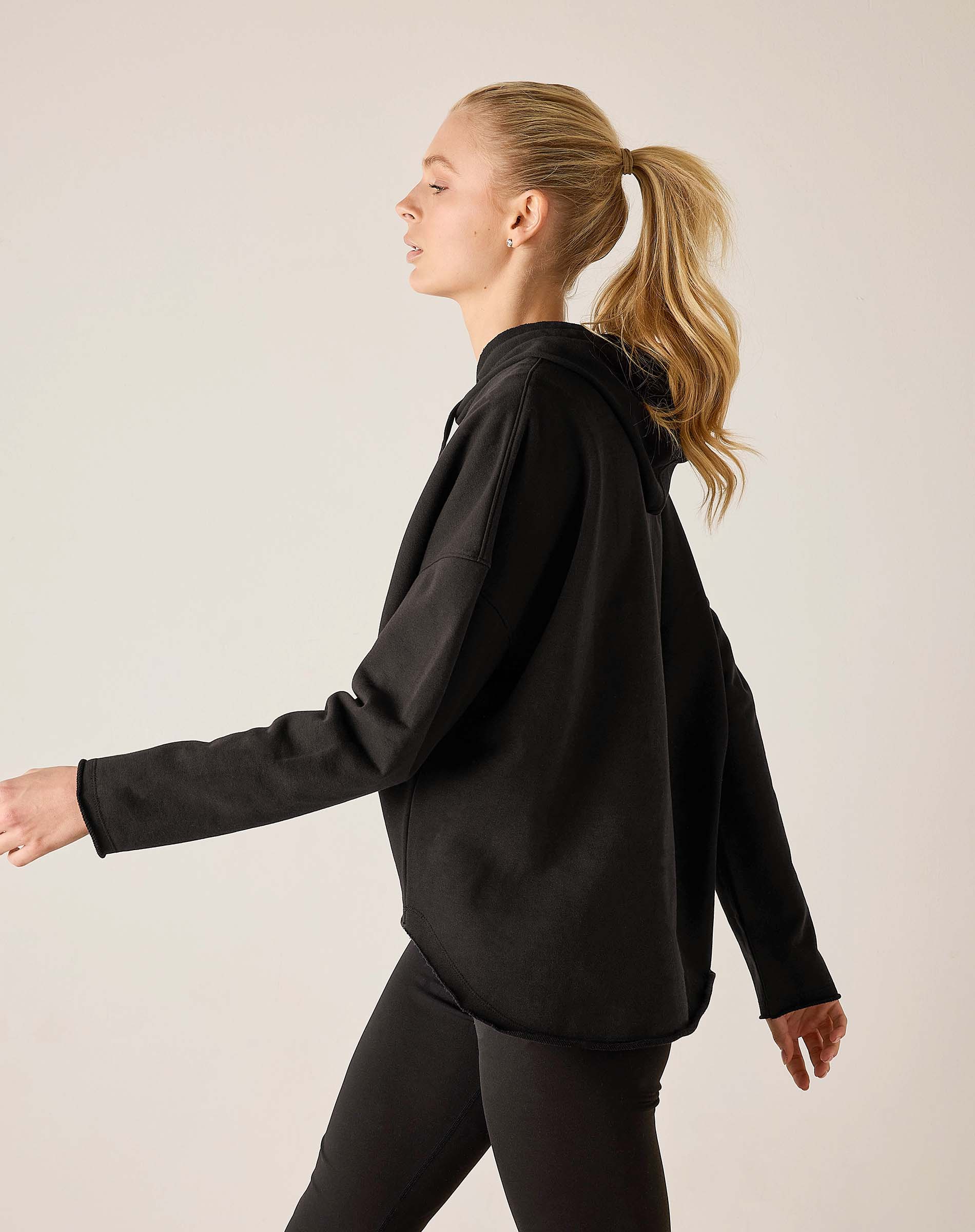 Black hoodie with a relaxed fit and drawstring hood.