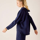 Side view of women's travel-friendly cadet blue hoodie with a drawstring hood and matching shorts.