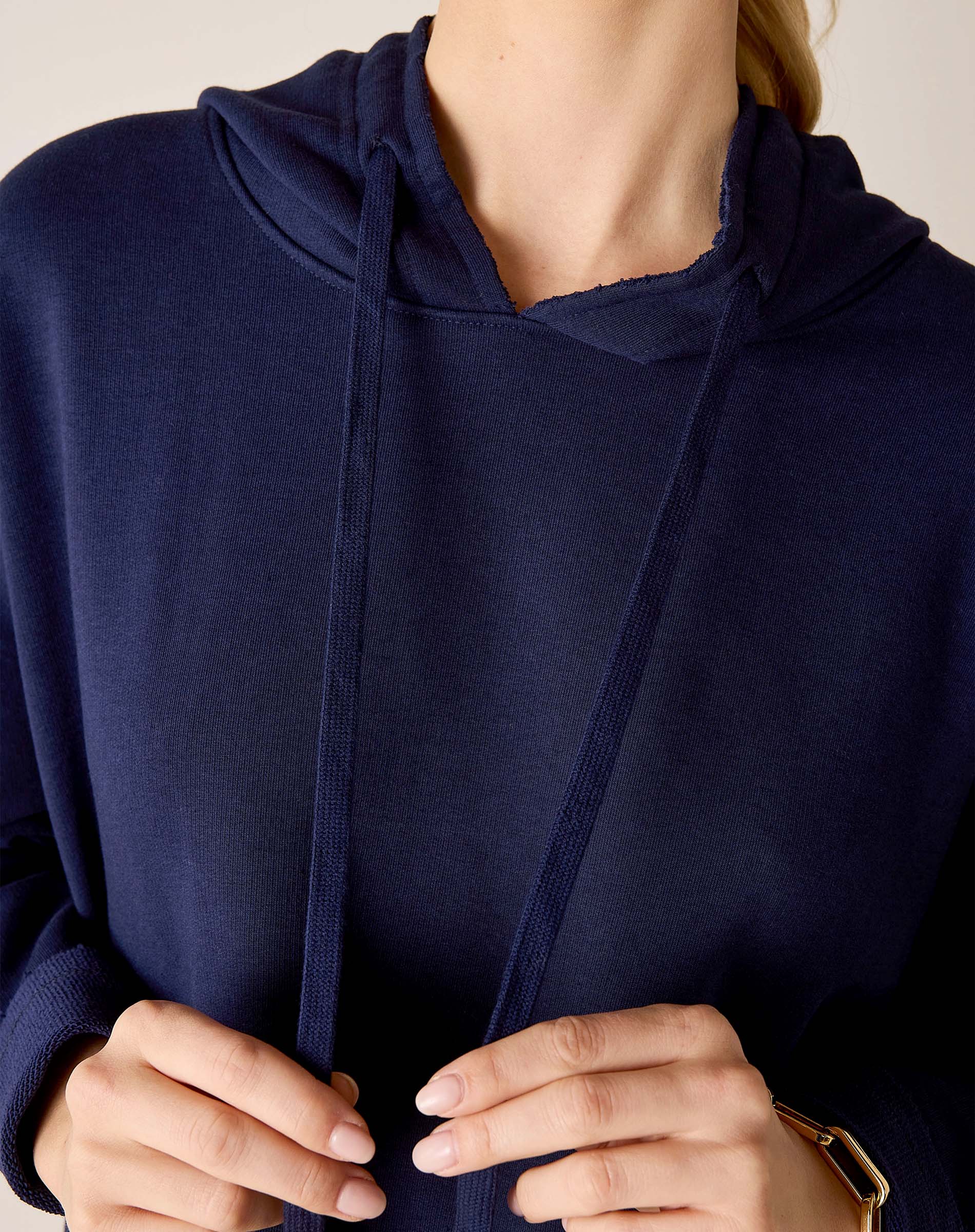 Cadet blue knit hoodie with drawstring and a relaxed fit.