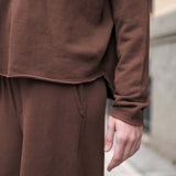 Espresso brown knit hoodie and matching wide-leg trousers.